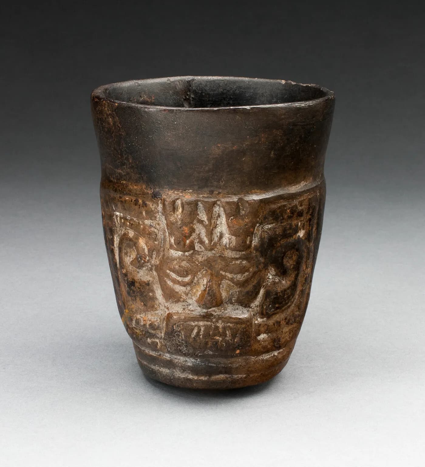 Museum work by Blackware Cup with Abstract Faces Carved in Panels by Lambayeque